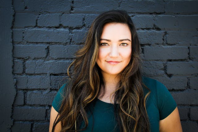 blue wall behind woman